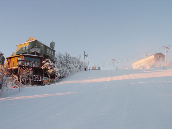 House on Slope With New Morning Snow